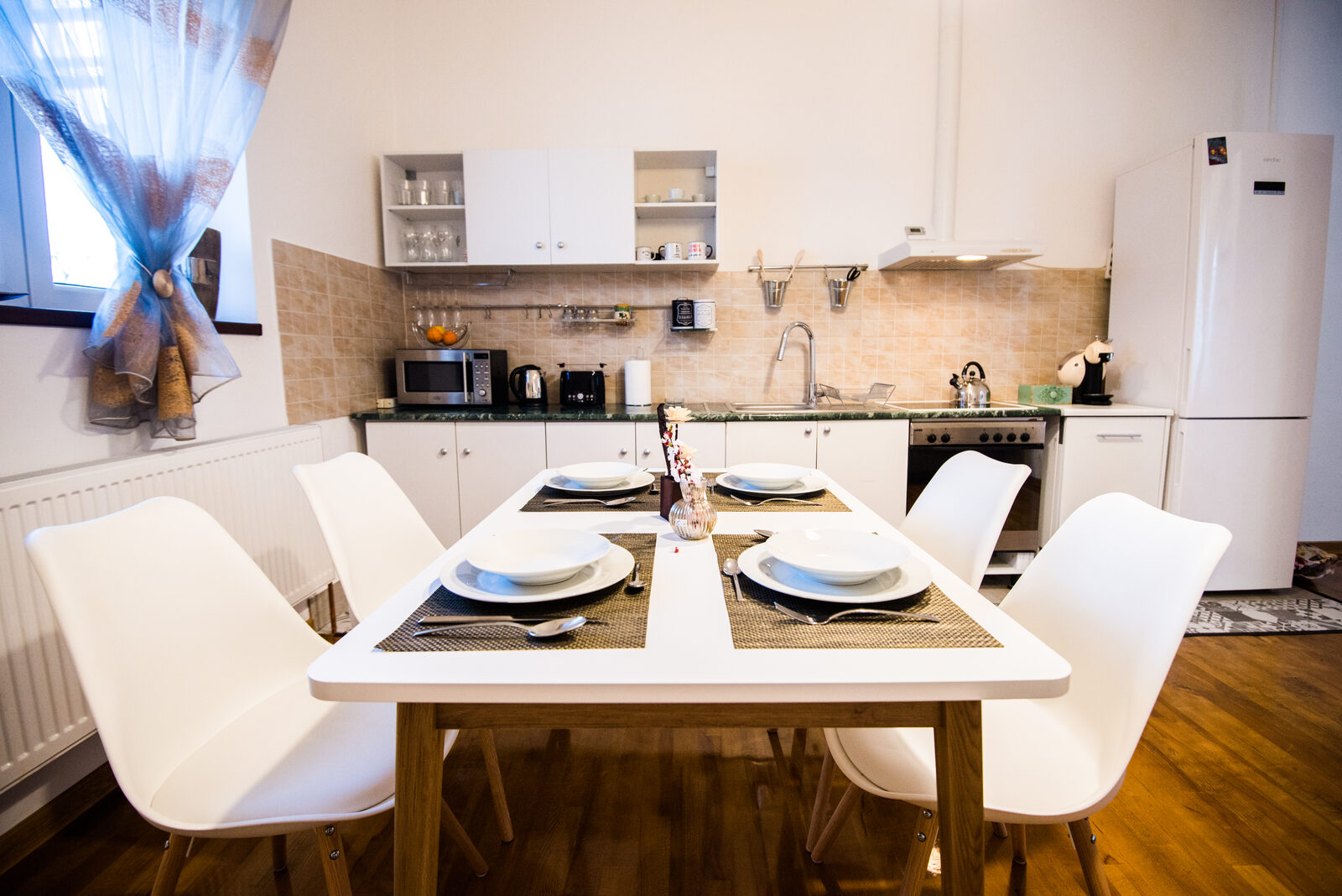 Set dining table with the kitchen in the background