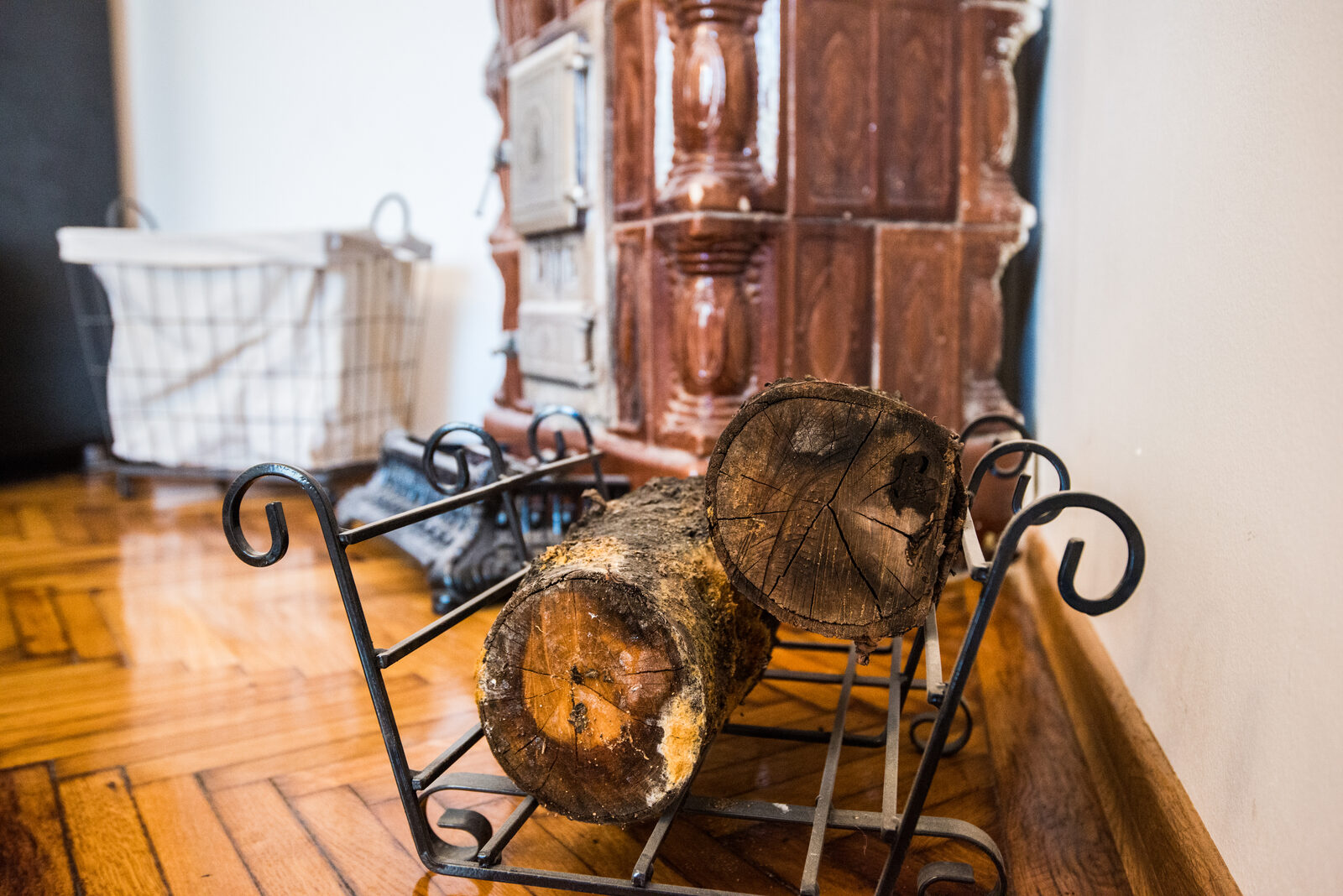 Detail of the antique tiled stove with firewood