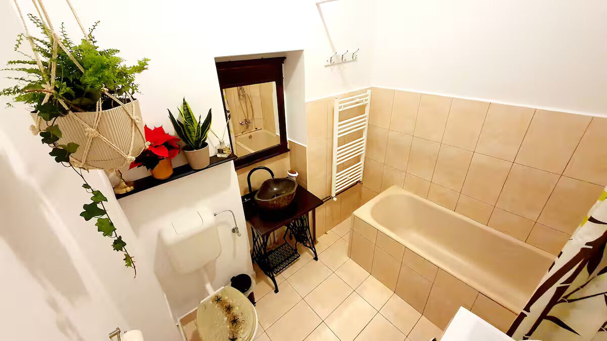 Full bathroom with tub and sewing-machine stand